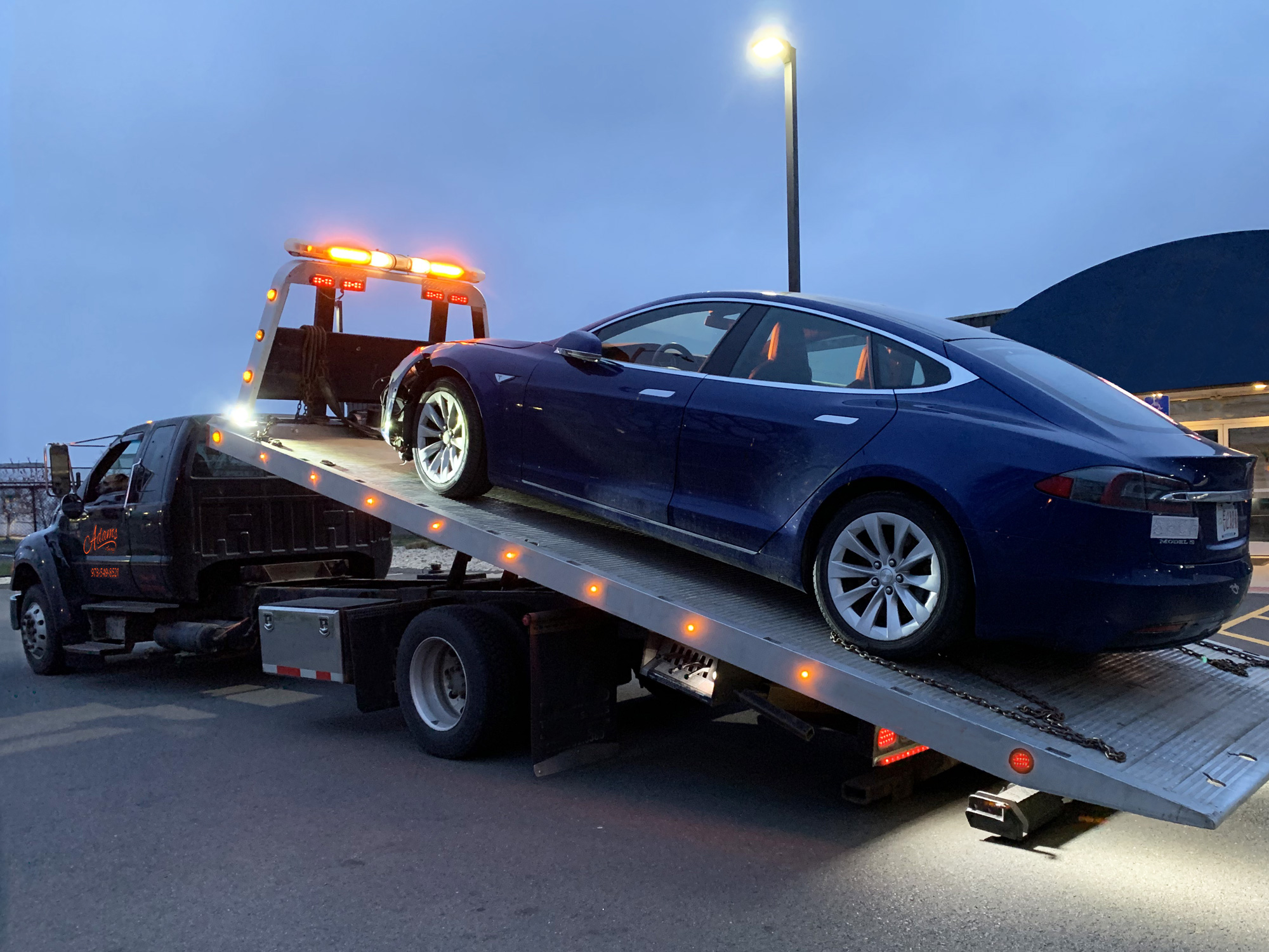 Tesla EV towed to auto body repair shop
